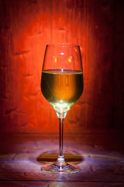Wine glass on red wooden background — Stock Photo, Image