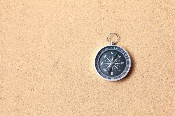 Compass on the sea sand — Stock Photo, Image