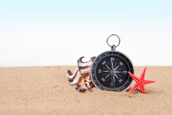 Compass, seashell on and starfish the sea sand — Stock Photo, Image