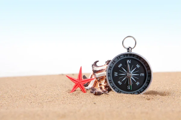 Compass, seashell on and starfish the sea sand — Stock Photo, Image