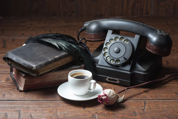 Cup of coffee, dry rose and old telephone — Stock Photo, Image