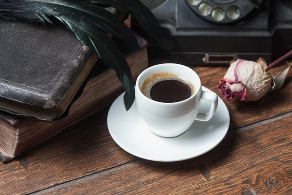 Cup of coffee, dry rose and old telephone — Stock Photo, Image