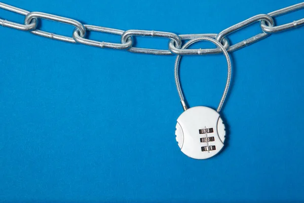 Cipher padlock on chain on blue background. Security concept. — Stock Photo, Image