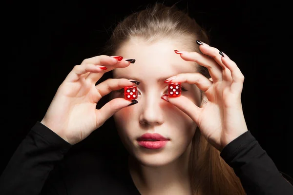 Young woman with red dice on black background — Stock Photo, Image