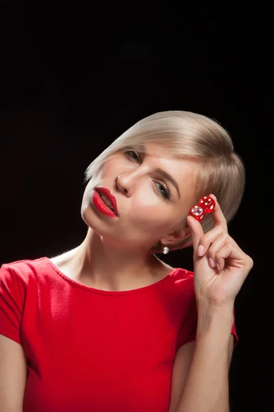 Young woman with red dices on black — Stock Photo, Image