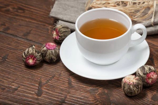 Tazza di tè con tè cinese fiore su vecchio tavolo di legno — Foto Stock