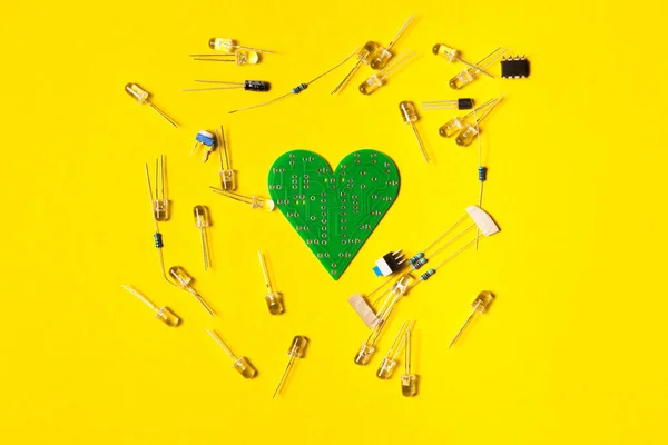 Electronic component, electric circuits, light-emitting diode, digital microchip and other on yellow background. DIY kit for learning, training and development. Flat lay design for banner or blog.