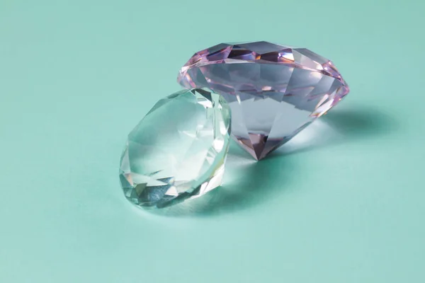 Precious gemstones for design gems jewellery. Big diamonds crystal on turquoise background.