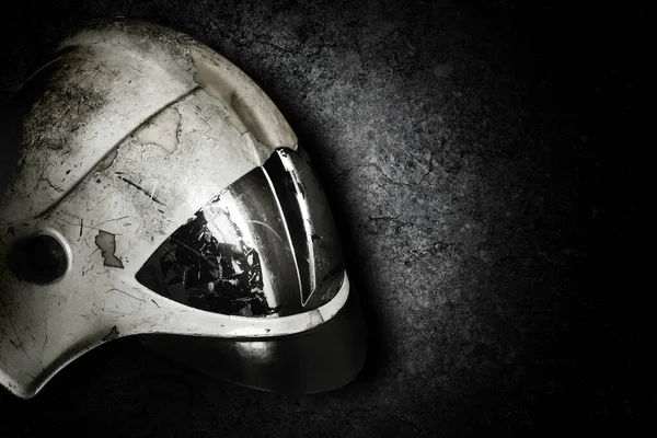 Safety helmet for fireman to protection him from danger. Helmet for firefighters for protection heat and falling objects. Helmet on darhk background with place for text.