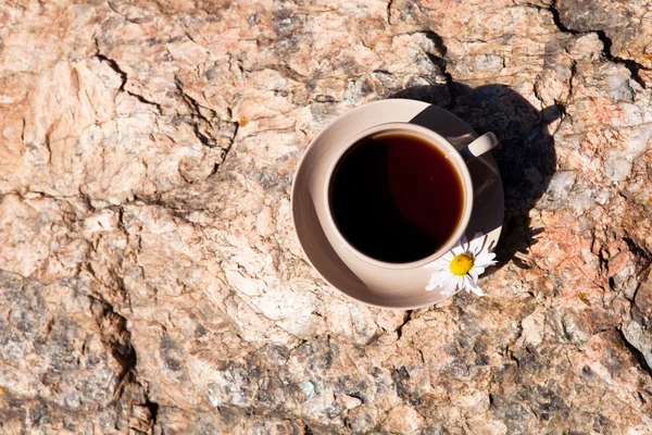 Tea with chamomile on old big stone. — Stock Photo, Image