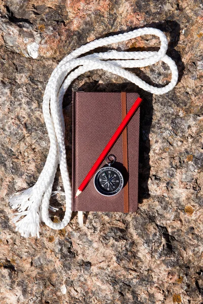 Notebook, compass, rope on stone background — Stock Photo, Image