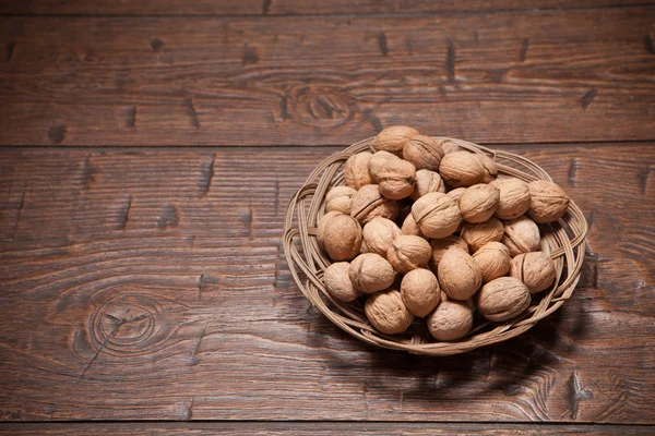 Walnuts on rustic old wooden table — Stock Photo, Image