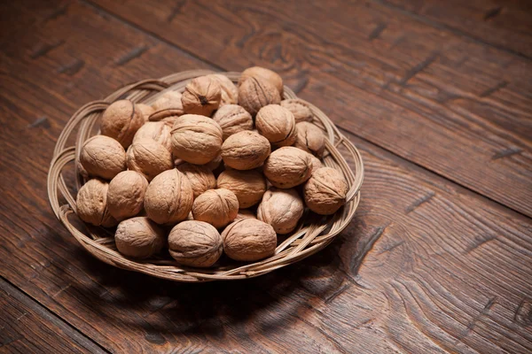 Walnuts on rustic old wooden table — Stock Photo, Image