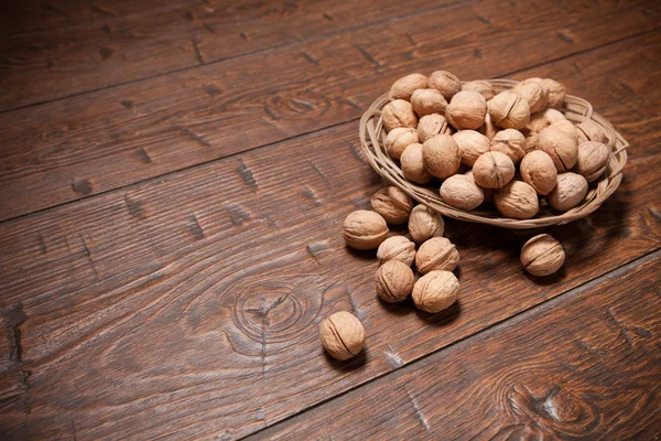 Walnuts on rustic old wooden table — Stock Photo, Image