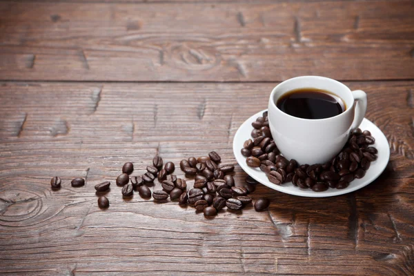 Coffee cup and saucer on wooden table — Stock Photo, Image