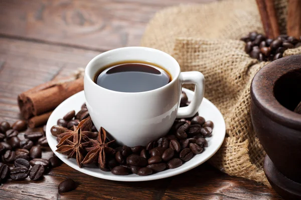 Cup of coffee with beans and spicery — Stock Photo, Image