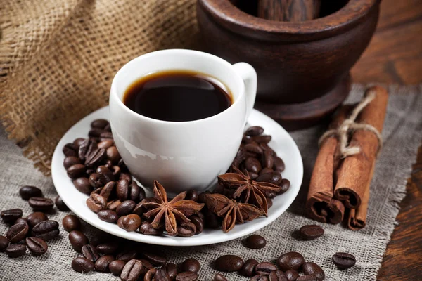 Cup of coffee with beans and spicery — Stock Photo, Image