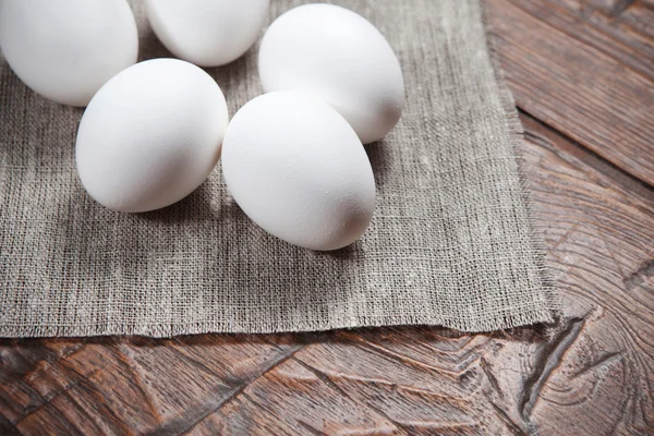 Яйца на деревянном деревенском столе — стоковое фото