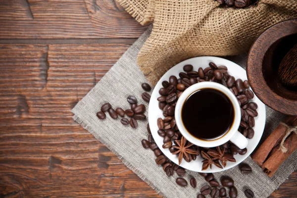 Cup of coffee with beans and spicery — Stock Photo, Image