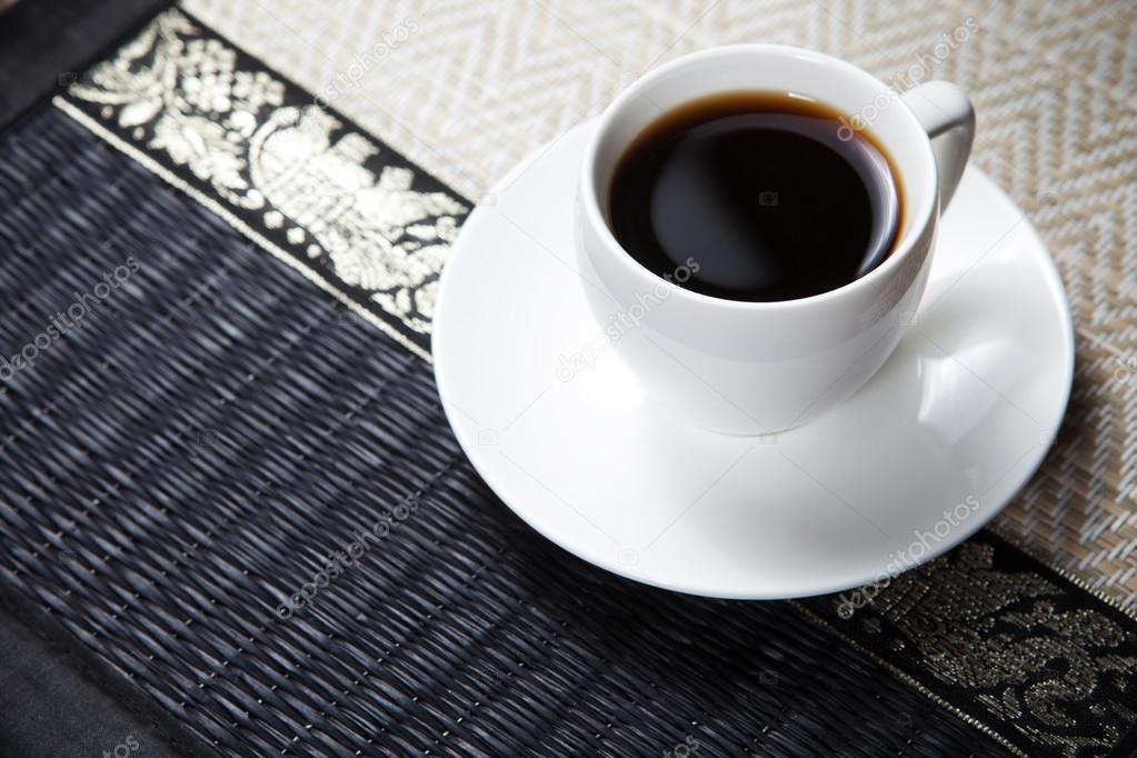 Coffee cup and saucer on wooden table