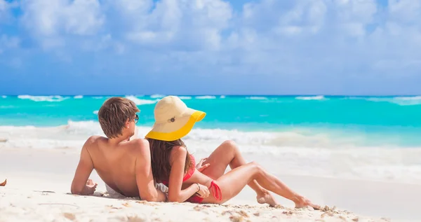 Vista posteriore della coppia seduta su una spiaggia tropicale alle Barbados — Foto Stock