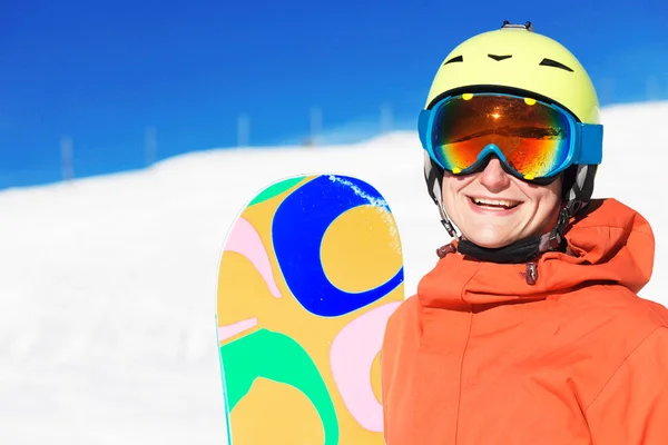 Portrait of a snowboarder smiling on the top of the mountains — Stock Photo, Image