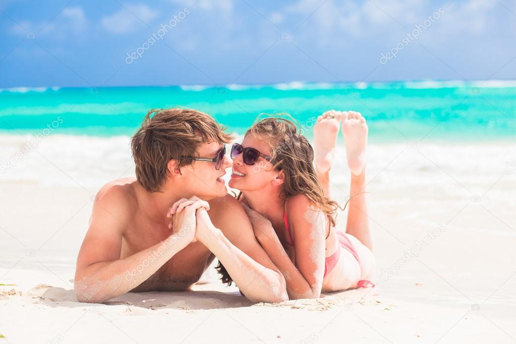 happy young couple kissing on a tropical beach in Barbados