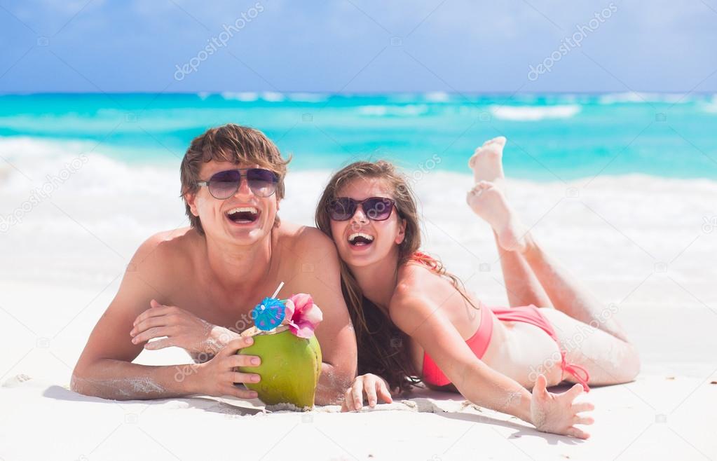 close up of young couple enjoying their time drinking a coconut cocktail