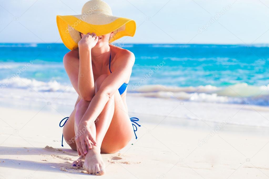 portrit of young woman in sun hat at beach