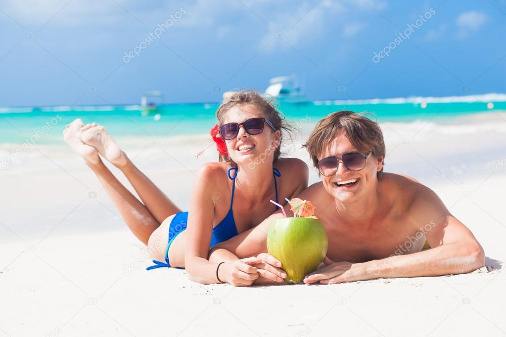 close up of young couple enjoying their time drinking a coconut cocktail