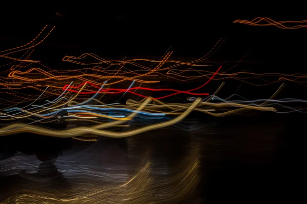 Light line left in the night sky and car headlights lights p — Stock Photo, Image