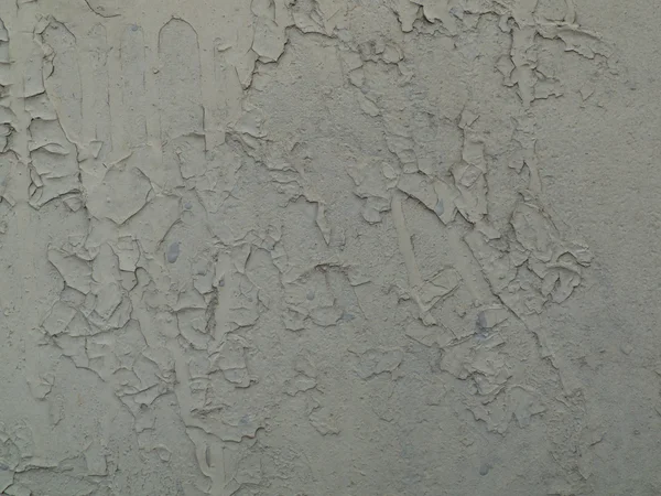 Pintura gris agrietada en una pared vieja — Foto de Stock