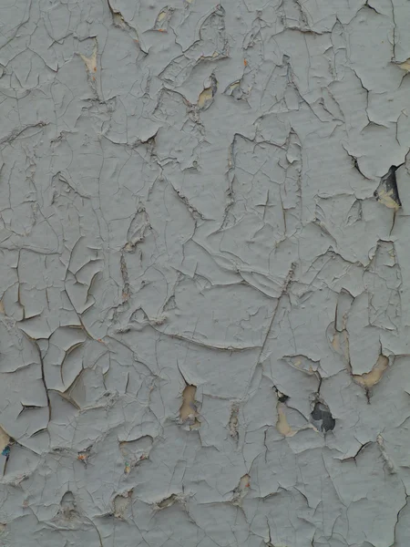 Pintura gris agrietada en una pared vieja —  Fotos de Stock