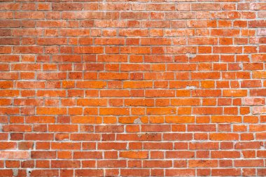 Kırmızı tuğla duvar. Modern bir çatı katının içinde. Fotoğraf ve video çekimi için arka plan. Bir tuğla binanın ön cephesi.