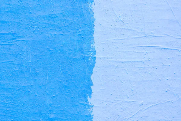 Blue paint texture. Interior of a modern loft. Abstract bright background. The facade of an old house. Divided in half.