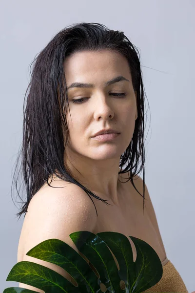 Beauty Woman with natural green palm leaf portrait. Fashion, beauty, make-up, cosmetics.