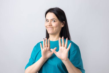 Rahatsız edici güzel esmer portresi, el hareketlerini durdurmak için kaldırıyor. Bu kadar yeter, teşekkürler..