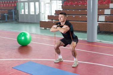 Spor giyimli atletik adam ve spor salonunda spor yapıyor..