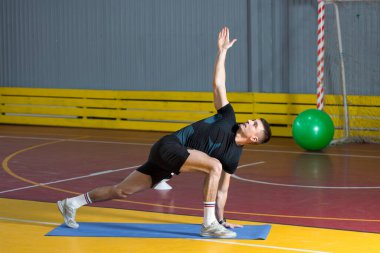 Spor giyimli atletik adam ve spor salonunda spor yapıyor..