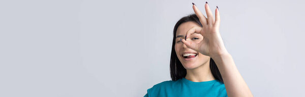 Smiling girl gesturing OK sign with her hand