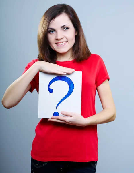 Nachdenkliches Mädchen in rotem T-Shirt vor grauem Hintergrund mit Fragezeichen — Stockfoto