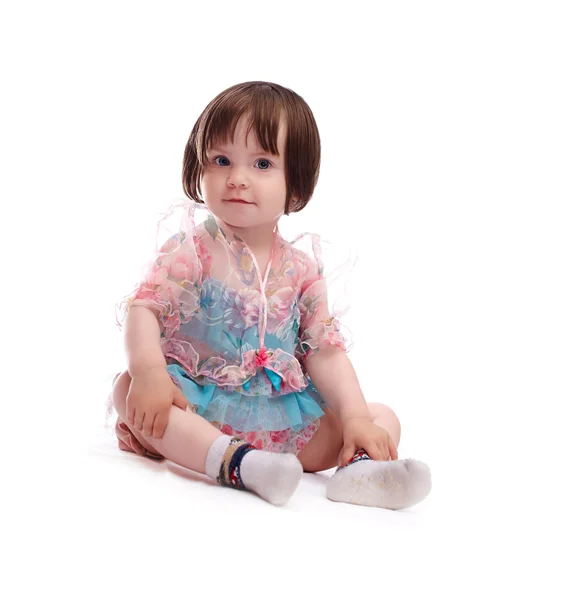 Niña sonriente bebé en un vestido colorido —  Fotos de Stock