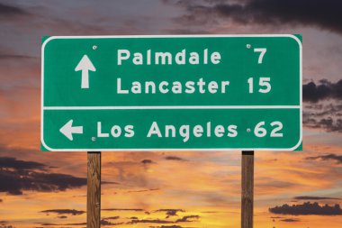 Palmdale, Lancaster and Los Angeles Highway Sign with Sunset Sky clipart