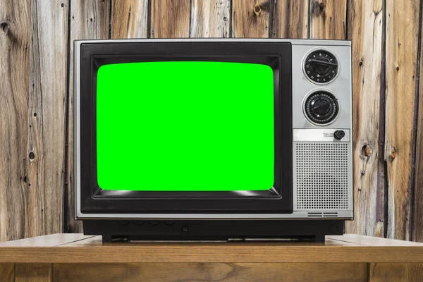 Analoge televisie met houten muur en Croma Key groen scherm Rechtenvrije Stockafbeeldingen