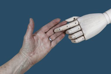 Gelecekte yaşlı bakımı. Bir robot el ve bir insan eli. Robot ve insan birbirine dokunur.