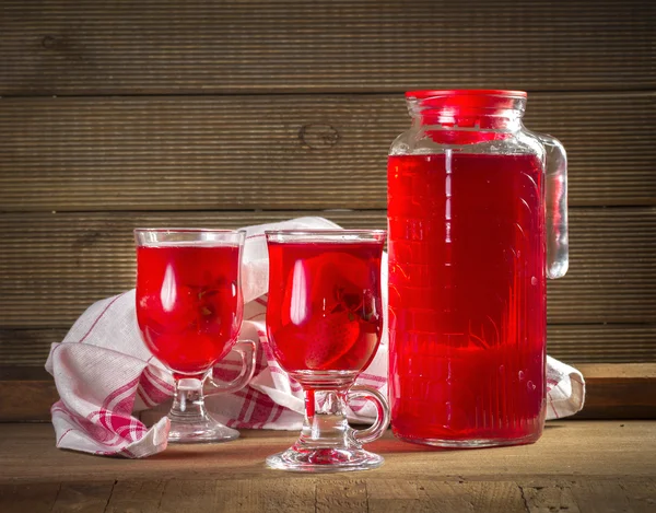 Jug and glasses with strawberry juice on vintage background — Stock Photo, Image