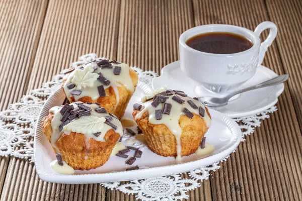 Delicious muffins with chocolate decoration — Stock Photo, Image