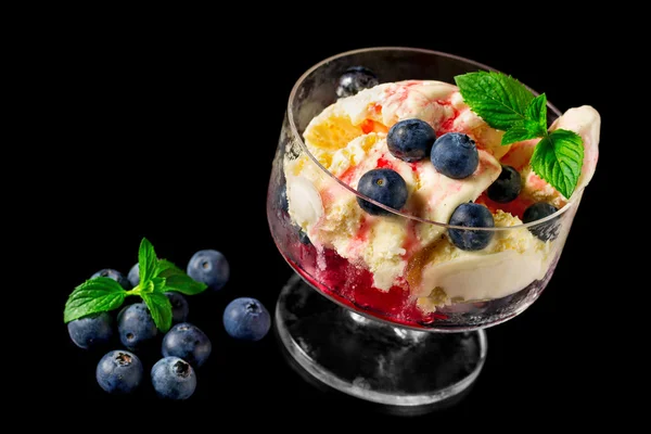 Vanilla ice cream with ripe blueberries on a black background — Stock Photo, Image