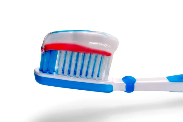 Cepillo dental azul con pasta de dientes tricolor. Aislar en un bac blanco — Foto de Stock