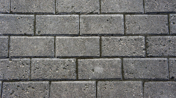 Gray brick stone road. Pavement texture photography.